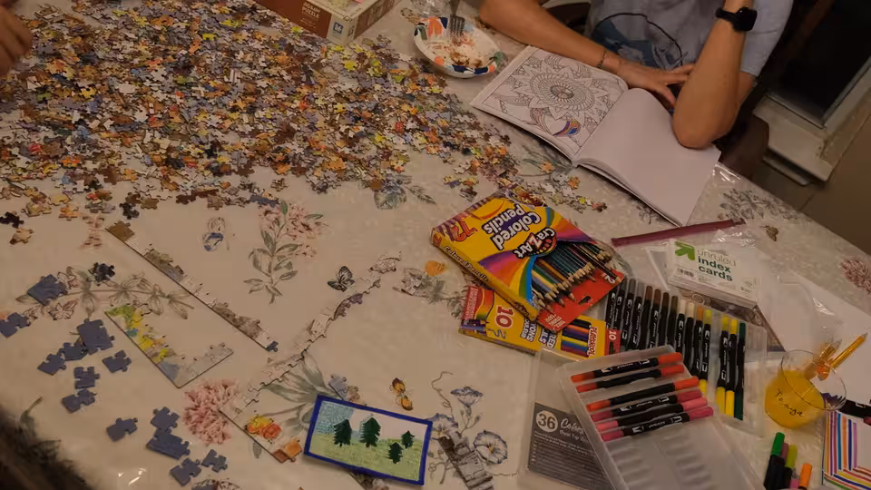 People working on a puzzle together at a phone-free event